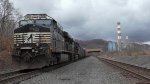 A empty coal train sits tied down on the Mon Line